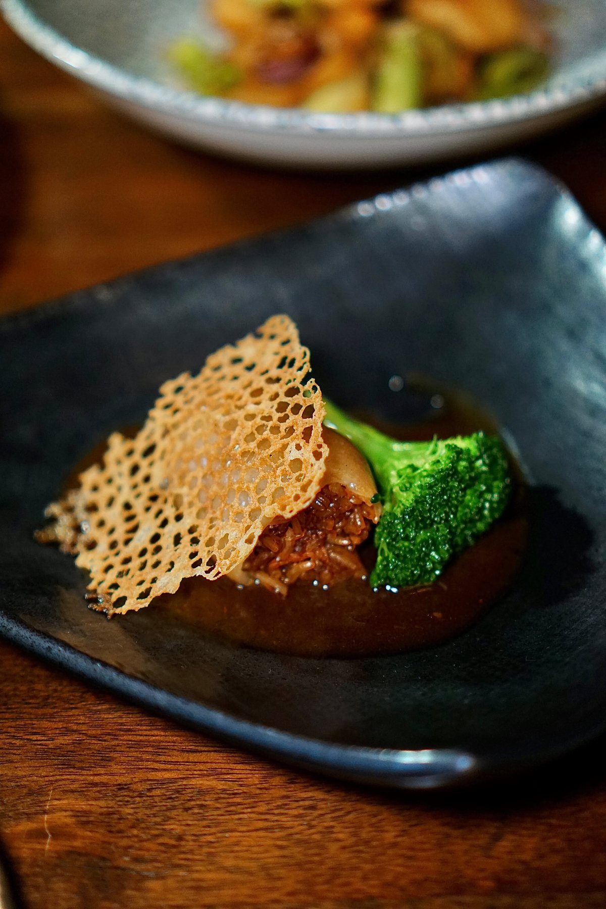 Roasted chicken presentation at Mott 32 Bangkok